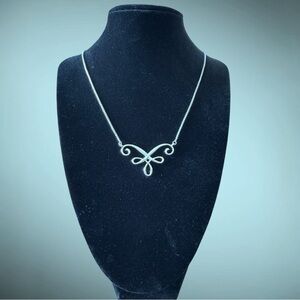 Silver colored Magnabilities necklace. Very shiny. Scroll design. NWOT